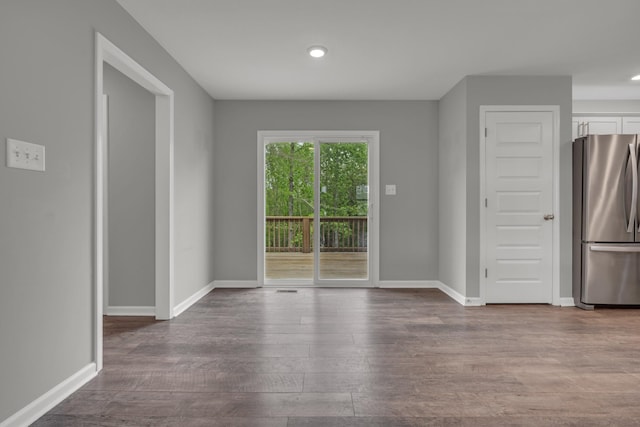 interior space with baseboards, recessed lighting, and dark wood finished floors