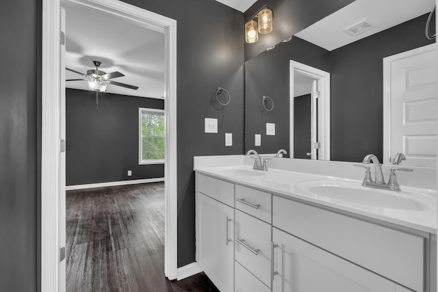 full bath featuring visible vents, a ceiling fan, baseboards, and a sink