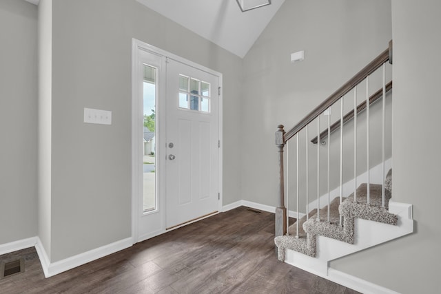 foyer entrance featuring stairs, wood finished floors, visible vents, and baseboards