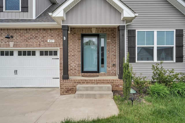 entrance to property featuring concrete driveway, brick siding, and board and batten siding