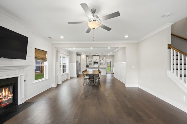 1239 Proprietors Pl, Murfreesboro, TN 37128 - living area featuring a fireplace with flush hearth, dark wood-style flooring, a ceiling fan, stairway, and ornamental molding
