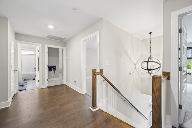 1239 Proprietors Pl, Murfreesboro, TN 37128 - hall with dark wood-style floors, visible vents, an upstairs landing, baseboards, and a notable chandelier