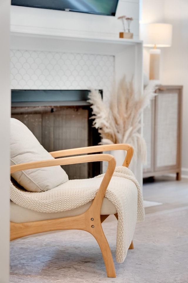 interior details with carpet and a tiled fireplace