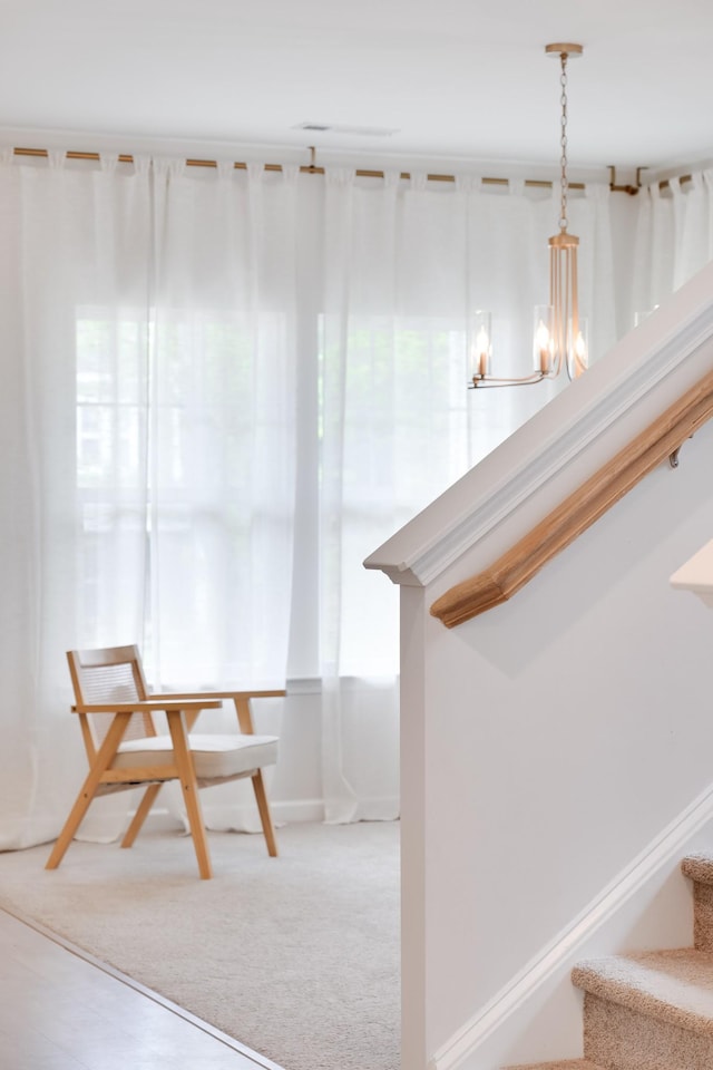 unfurnished dining area with baseboards, an inviting chandelier, and stairs