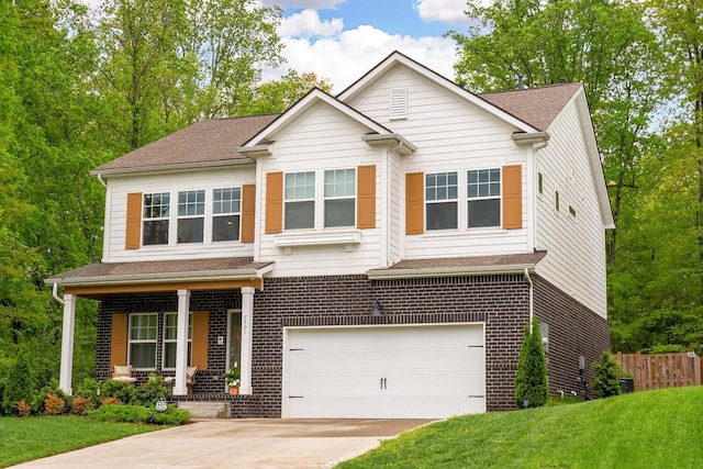 craftsman inspired home with covered porch, fence, a front yard, concrete driveway, and an attached garage