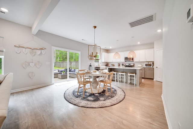 dining room featuring baseboards, recessed lighting, and light wood-style flooring