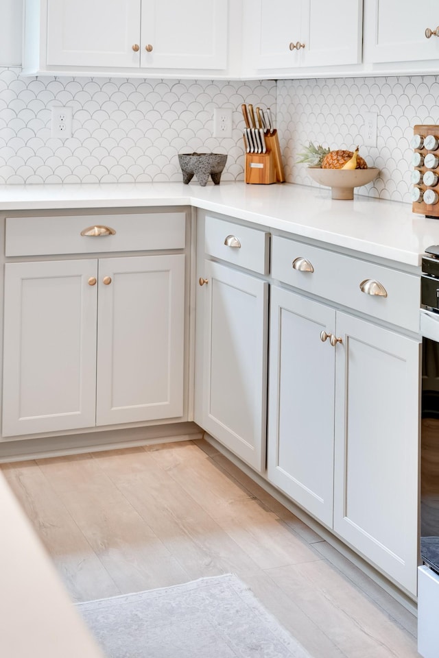 kitchen featuring light countertops and backsplash