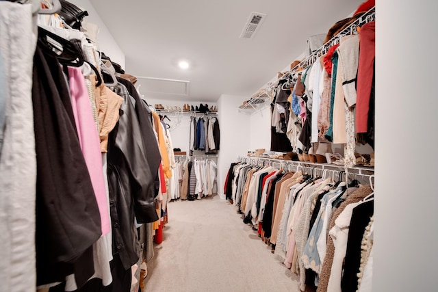 spacious closet featuring attic access, visible vents, and carpet flooring