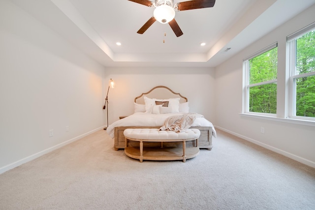bedroom featuring recessed lighting, a tray ceiling, a ceiling fan, baseboards, and carpet floors