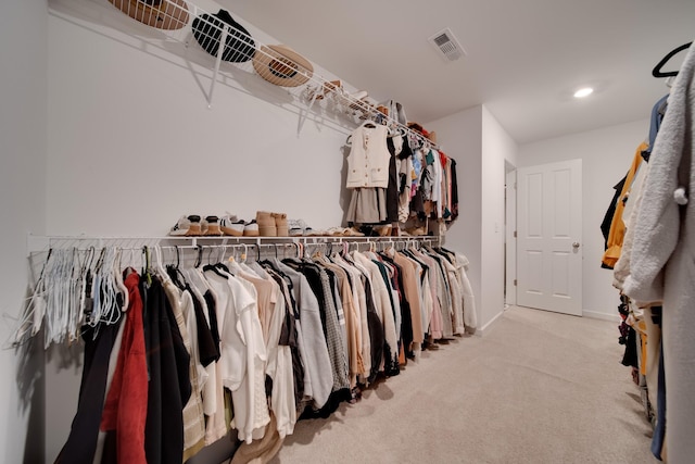 walk in closet featuring visible vents and carpet