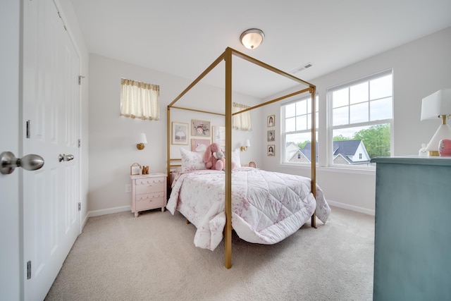 bedroom with light colored carpet, visible vents, and baseboards
