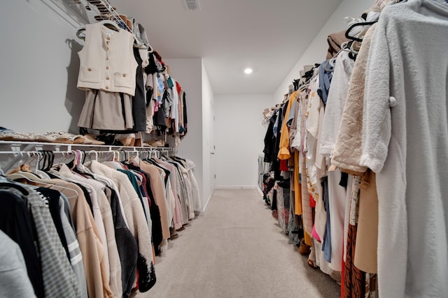 spacious closet featuring light carpet