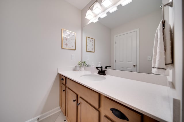 bathroom featuring tile patterned flooring, vanity, and baseboards