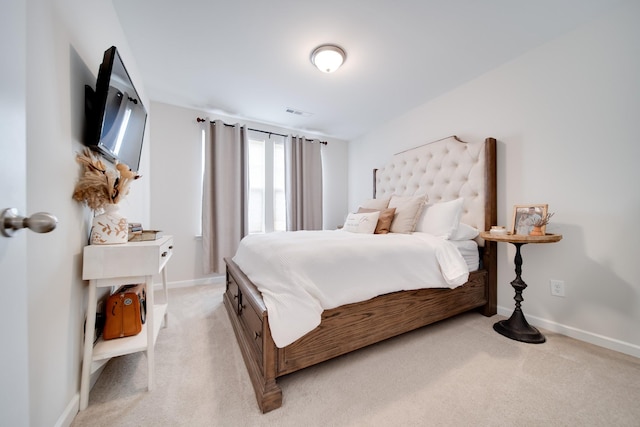 bedroom with visible vents, light colored carpet, and baseboards