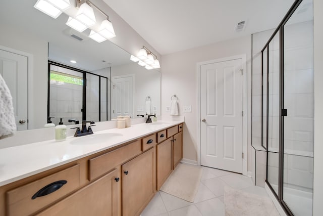 bathroom featuring a sink, a shower stall, and visible vents