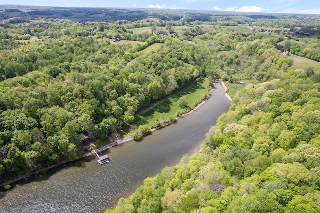 aerial view with a wooded view and a water view