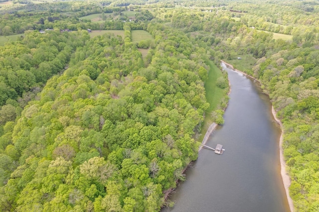 aerial view featuring a forest view and a water view