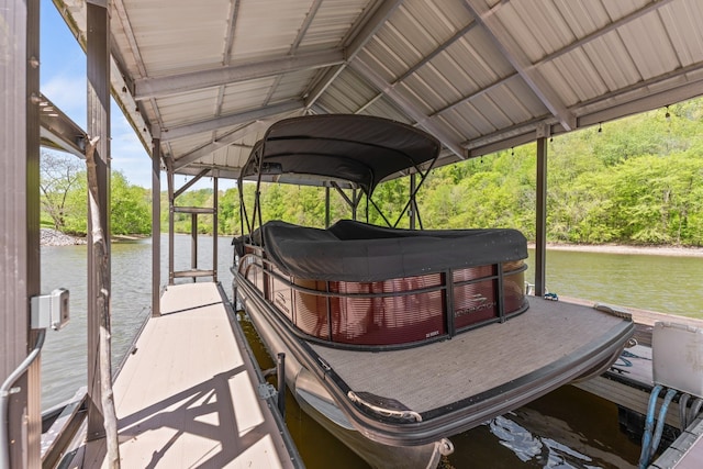 dock area with boat lift and a water view