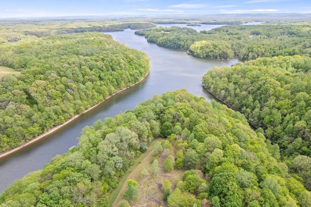 aerial view featuring a wooded view and a water view