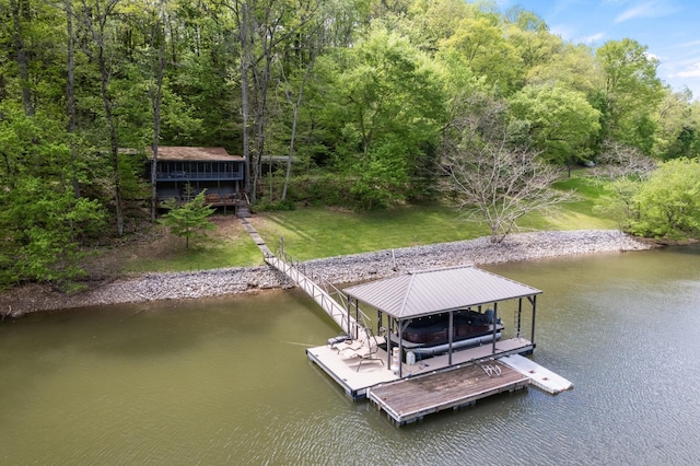 view of dock featuring a view of trees, a yard, boat lift, and a water view