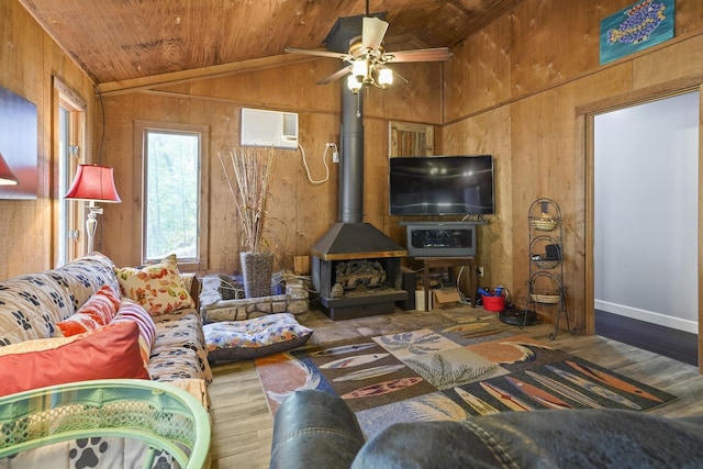 living room featuring wooden ceiling, an AC wall unit, a wood stove, and wood finished floors