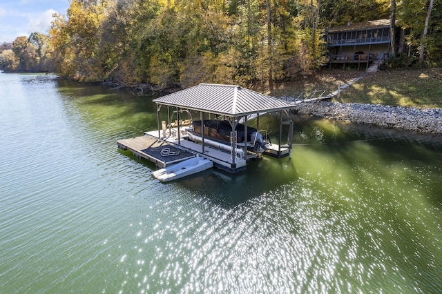 dock area featuring boat lift, a water view, and a wooded view