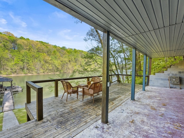 wooden deck featuring a view of trees and a water view