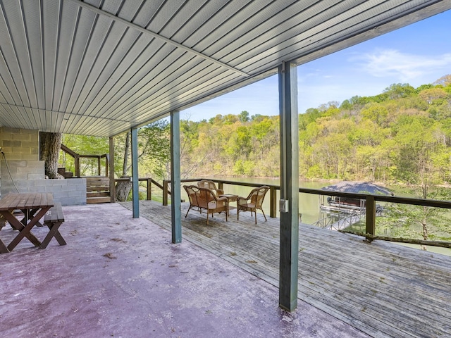 wooden terrace featuring a forest view