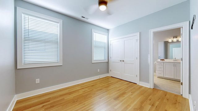 6412B Edsel Dr, Nashville, TN 37209 - unfurnished bedroom featuring light wood-type flooring, a sink, baseboards, ensuite bath, and a closet