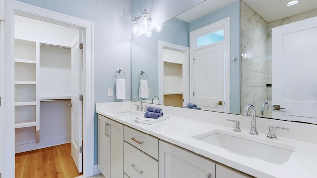 6412B Edsel Dr, Nashville, TN 37209 - bathroom with a spacious closet, wood finished floors, double vanity, and a tile shower