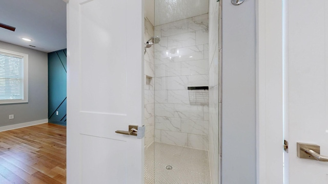 6412B Edsel Dr, Nashville, TN 37209 - bathroom with a tile shower, wood finished floors, and baseboards