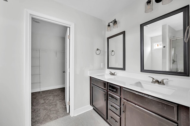 350 Galway Dr, Clarksville, TN 37042 - bathroom with double vanity, a shower with door, a walk in closet, and baseboards