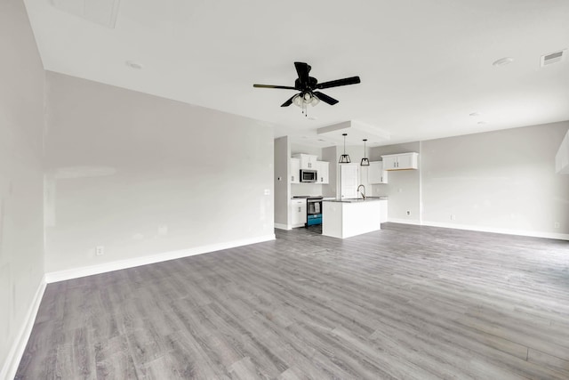 350 Galway Dr, Clarksville, TN 37042 - unfurnished living room with wood finished floors, a ceiling fan, and baseboards