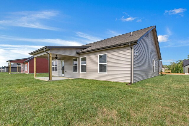 358 Galway Dr, Clarksville, TN 37042 - back of property featuring a ceiling fan, a patio area, a lawn, and roof with shingles