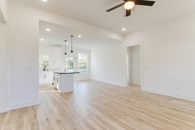unfurnished living room with recessed lighting, light wood-type flooring, and a ceiling fan