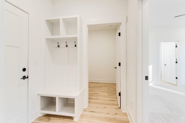 mudroom featuring baseboards and wood finished floors