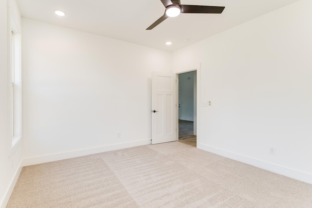 unfurnished room with recessed lighting, baseboards, a ceiling fan, and light colored carpet
