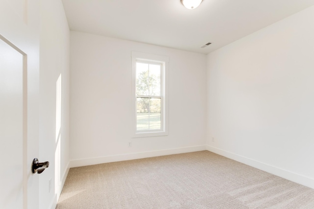 empty room with light carpet and baseboards