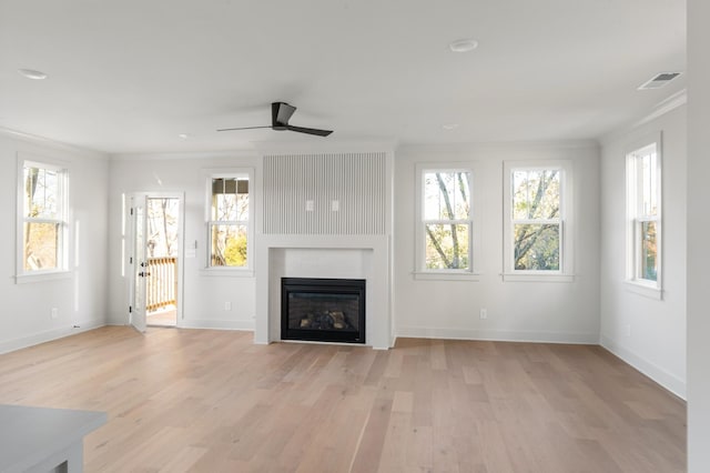 430 Mercomatic Dr, Nashville, TN 37209 - unfurnished living room featuring light wood finished floors, visible vents, a ceiling fan, baseboards, and a glass covered fireplace