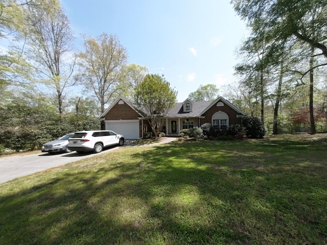 view of front of property featuring driveway, a front yard, and a garage