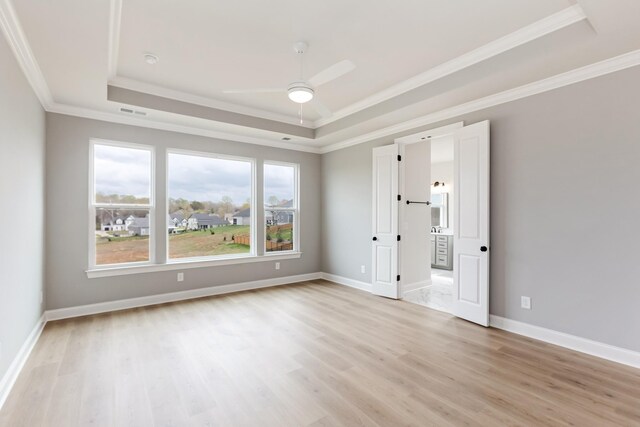 7408 Black Fox Dr, Fairview, TN 37062 - empty room with a raised ceiling, ornamental molding, light wood-type flooring, baseboards, and ceiling fan