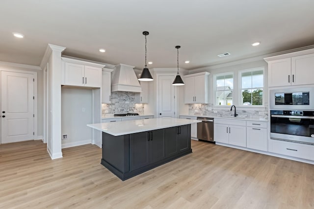 7408 Black Fox Dr, Fairview, TN 37062 - kitchen with stainless steel appliances, light countertops, a sink, custom exhaust hood, and white cabinetry