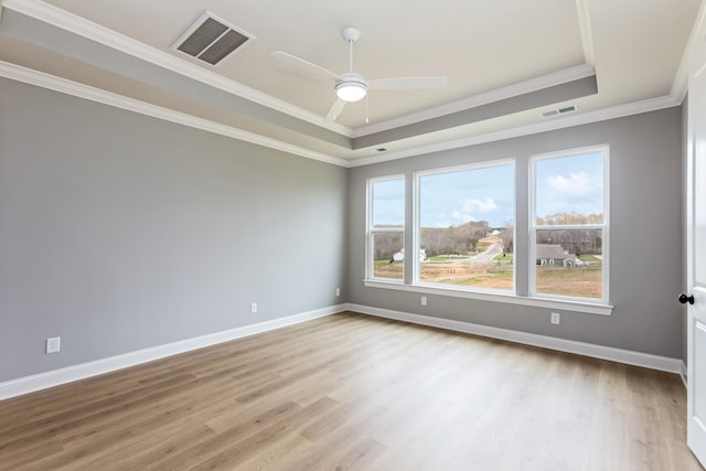 7408 Black Fox Dr, Fairview, TN 37062 - spare room with visible vents, light wood-style floors, a raised ceiling, and crown molding