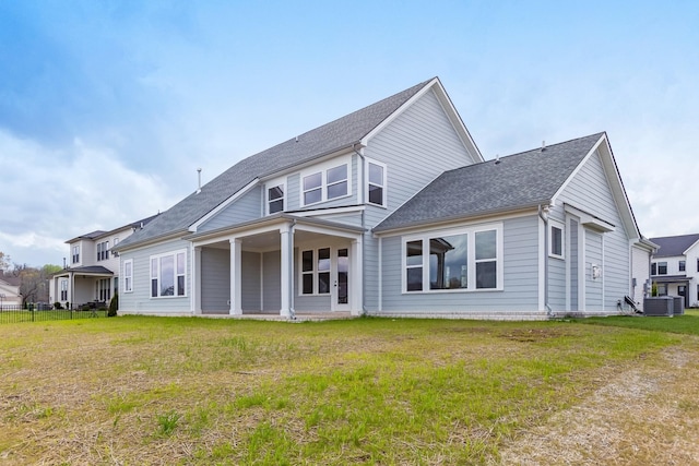 7408 Black Fox Dr, Fairview, TN 37062 - back of house with a lawn, roof with shingles, and central AC