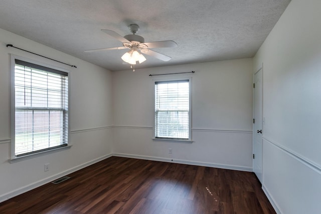 spare room with visible vents, a ceiling fan, a textured ceiling, and wood finished floors