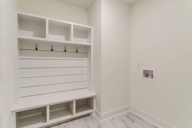 mudroom with baseboards and marble finish floor
