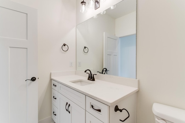 bathroom with toilet and vanity
