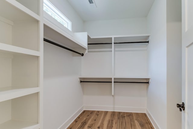 walk in closet featuring wood finished floors