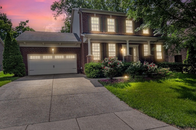 view of front facade featuring brick siding, driveway, a garage, a front lawn, and a porch