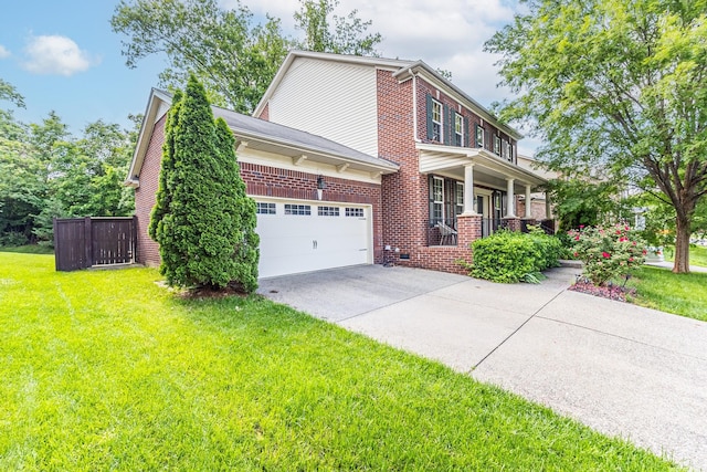 view of front of property with brick siding, concrete driveway, a front lawn, an attached garage, and covered porch